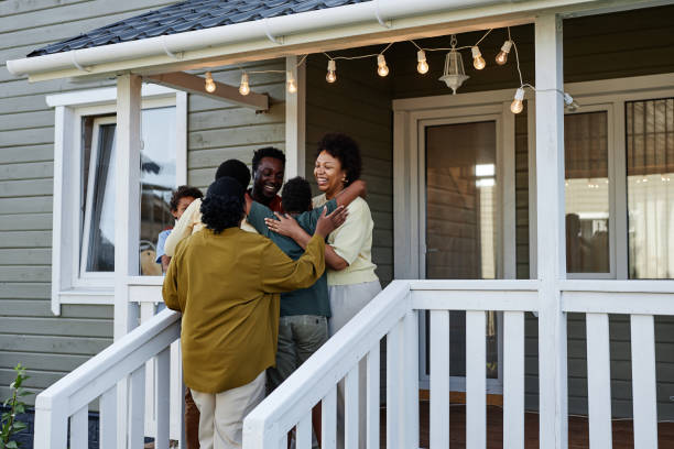 Black Family Embracing By House
