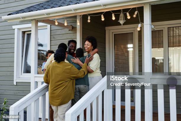 Black Family Embracing By House Stock Photo - Download Image Now - Home Ownership, Family, Happiness