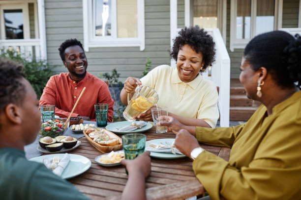 istock Black Family Enjoying Dinner Together in Summer 1434816483