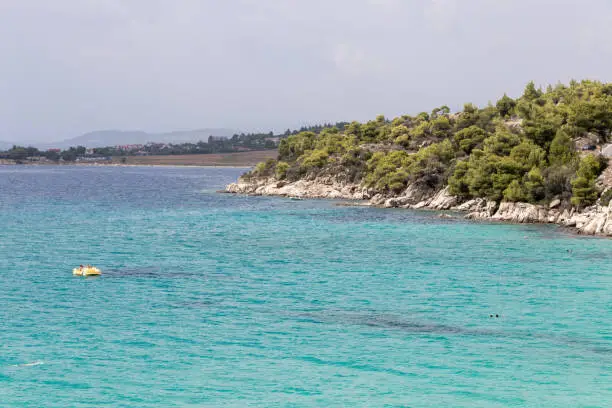 Photo of Akti Koviou beach on Sithonia peninsula, Chalkidiki, Greece. Summer vacation travel holiday background concept.