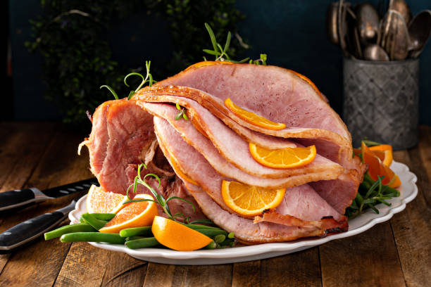 istock Christmas or Thanksgiving spiral sliced ham with oranges and herbs 1434818300