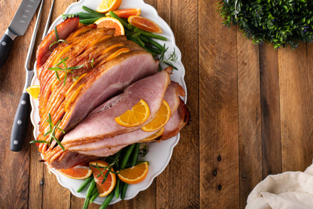 istock Christmas or Thanksgiving spiral sliced ham with oranges and herbs 1434818315