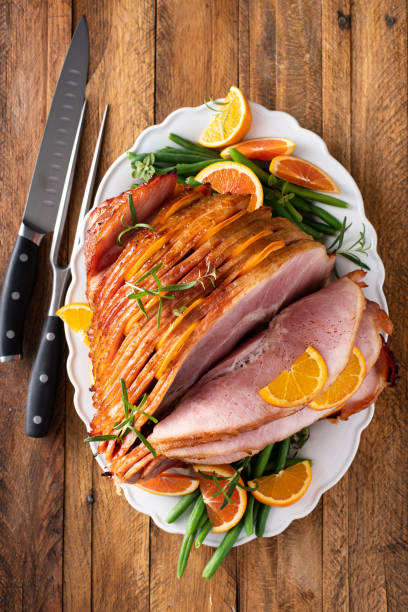 istock Christmas or Thanksgiving spiral sliced ham with oranges and herbs 1434818327
