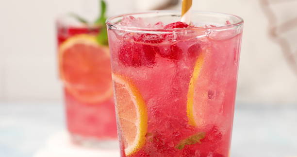 istock Spring or summer cold cocktail, raspberry lemonade being stirred with a straw 1434818331