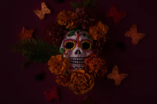 Photo of Dia De Los Muertos or Day of the Dead Celebration Banner with Empty Space. Low key photo of Scull Decorated with Marigold flower. Mexican Festive.