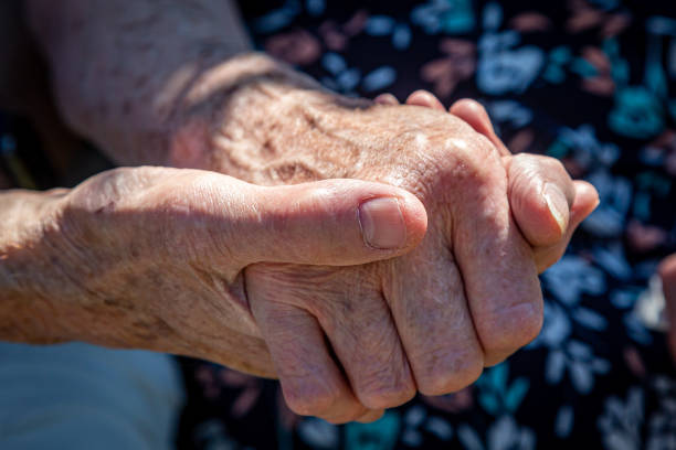 istock An elderly couple holding hands, with a shallow depth of field 1434818802