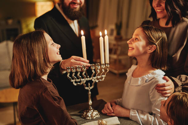 istock Kids Looking at Menorah Candle 1434820338