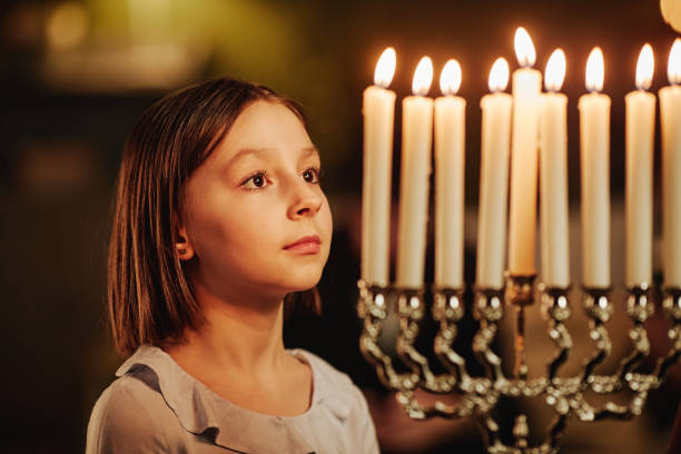 Girl Looking at Menorah Candle