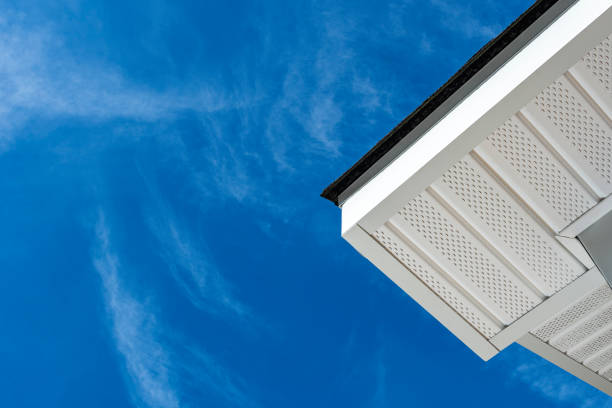 Looking up at newly installed fascia, soffit and asphalt shingles on a residential home addition stock photo