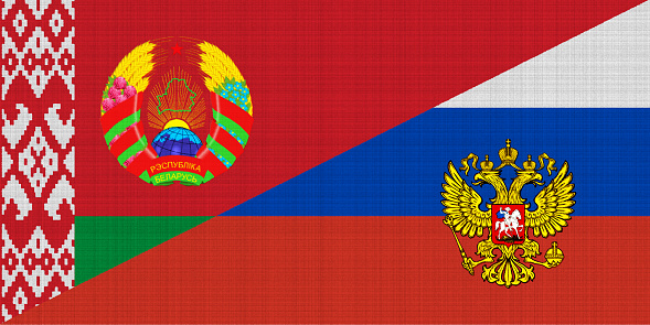 Flags of Russia and Belarus on textured fabric. Concept of cooperation between two countries