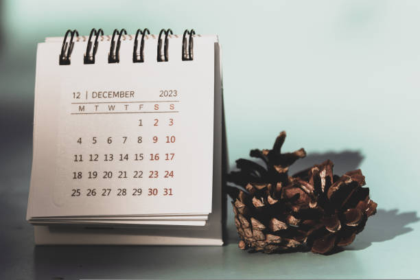 istock A small calendar with December 2023 on it, several pine cones are lying nearby 1434832693