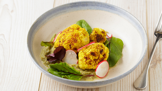 homemade roasted cauliflower with cauliflower puree, radish, and baby red chard