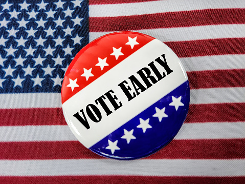 Early voting election pin on an American flag