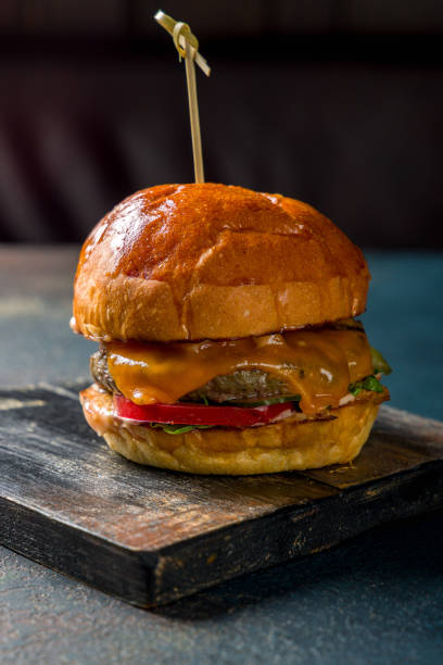 istock cheeseburger on the Board with meat cutlet and vegetables vertical 1434836424