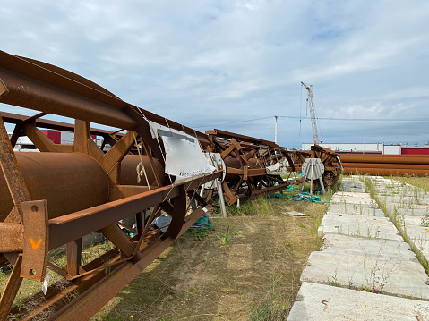 Old rusty equipment for a chemical plant or mining and processing plant in the open air for storing materials and industrial equipment.