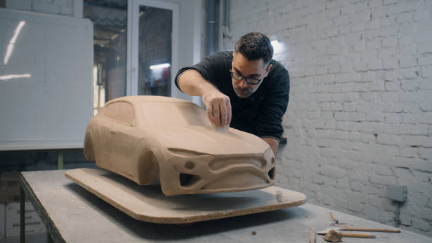 istock Automotive designer sculpts the prototype model of the car using sculpting tools 1434837183