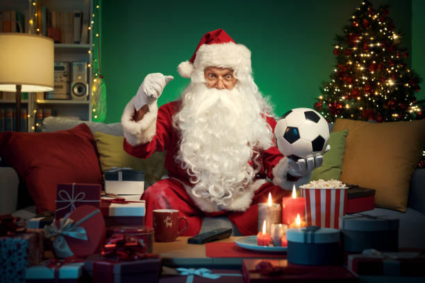Happy Santa Claus watching soccer on TV stock photo