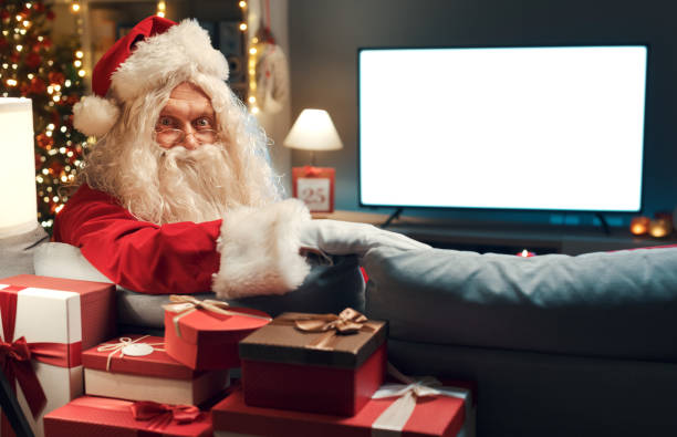 istock Santa Claus watching television at home 1434838573