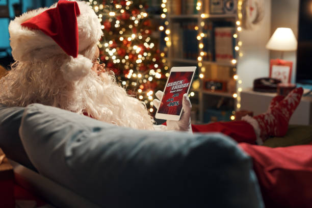 istock Santa Claus watching a Black Friday sale advertisement 1434838709