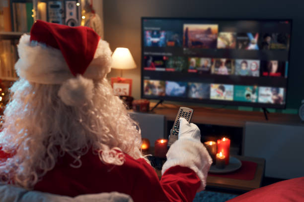 Santa Claus choosing a movie on TV stock photo