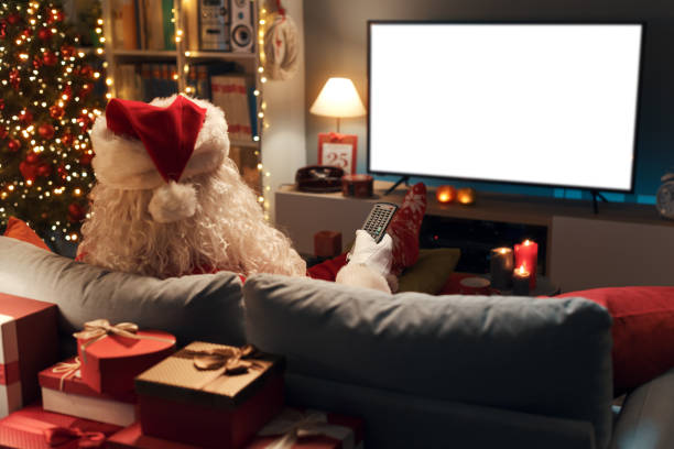 istock Santa Claus watching television at home 1434839451