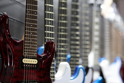 Electric guitars on a wall in music store. Selective focus.