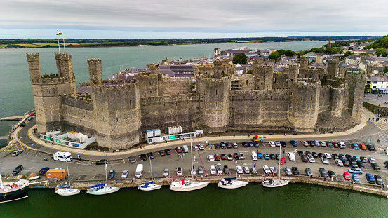 Aerial view of the ancient Caernarfon Castle in North Wales.  The castle is currently undergoing repair work and was used for the investiture of Prince's of Wales.