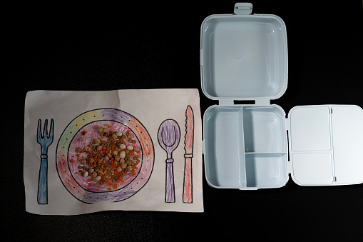 Photo of preschool student drawing of plate with grains of lentil, chickpea, nuts etc. No people are seen in frame .Shot with a full frame mirrorless camera.
