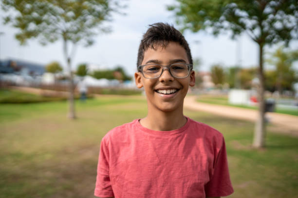 Portrait of boy laughing in public square stock photo