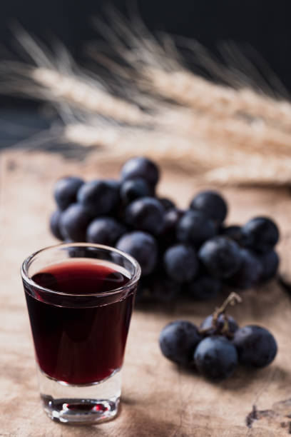 istock Black grape juice in glass on wooden 1434860833