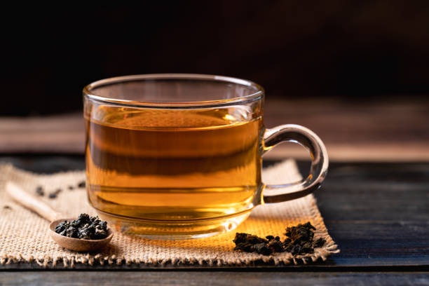 istock Hot tea in cup glass with dried tea leaves 1434861014