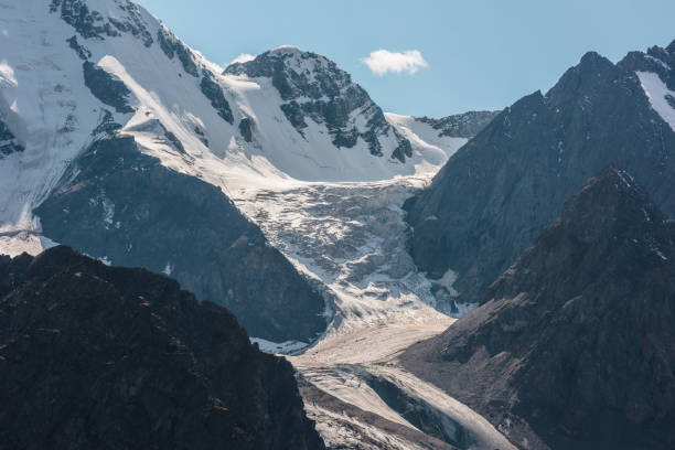 istock Atmospheric landscape with large snow mountain range in sunny day. Glacier and icefall in bright sun among sharp rocks. Awesome view to high snowy mountains. Snow-covered mountain wall with glacier. 1434866362