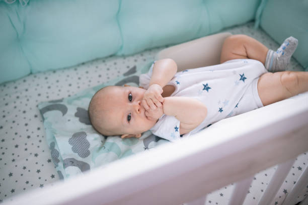 Baby boy laying and itching gums because of teeting.