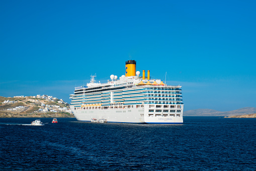 Mykonos, Greece - May 29, 2019: Cruise liner ship Costa Luminosa in Mediterranean sea near Mykonos island. Aegean sea, Greece