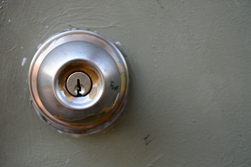 Modern glass and metallic dark front door with chrome handle and digital lock from inside, copy space