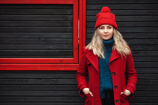 Portrait of a beautiful young woman in winter clothing. Red Color Concept
