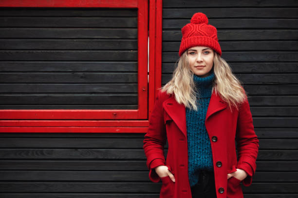 Portrait of abeautiful woman wearing red jacket in winter stock photo