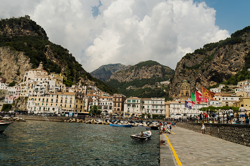 Amalfi,Italy: August 27,2022- Panoramic view of dal molo al tramonto in Amalfi packed with tourists