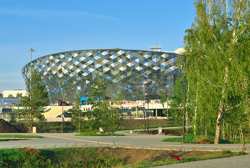Novosibirsk, Siberia, Russia, 09.03.2022. New buildings of a big city. Glass diamond facade of the ice hockey arena under construction