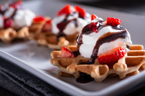 Homemade Waffle Dessert with Strawberries, Whipped Cream and Chocolate Syrup