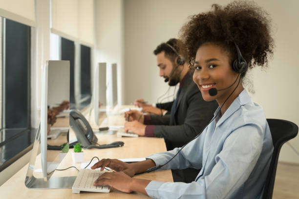 istock smiling mixed race female call center or help desk or telephone support agent working at call center 1434878669