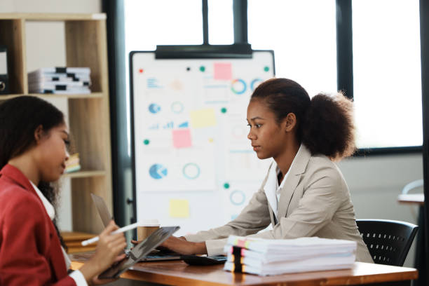 istock two women discussing business plans in the office 1434879714