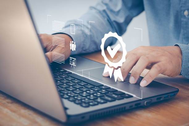 istock ISO certification and standardization concept. Business person working on laptop computer with the sign of the top service Quality assurance, Guarantee, Standards, certificate, warranty, satisfaction. 1434879838