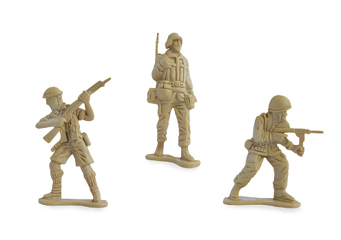 Collection of miniature toy soldiers with guns isolated on white background with clipping path. Toy plastic soldiers for young kid.