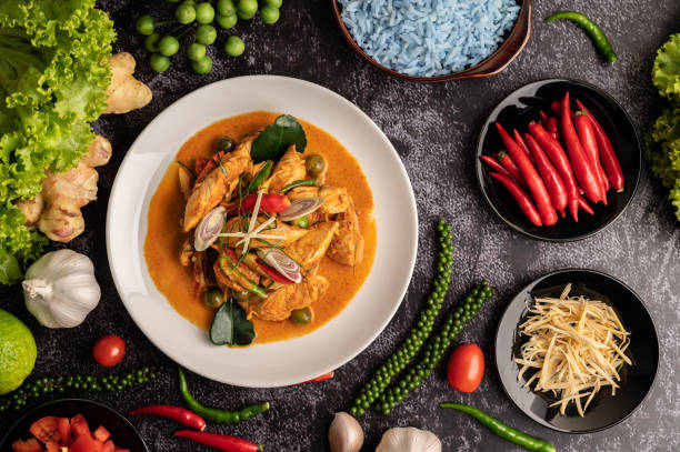 istock Dry green curry with chicken in white plates on black cement 1434883564