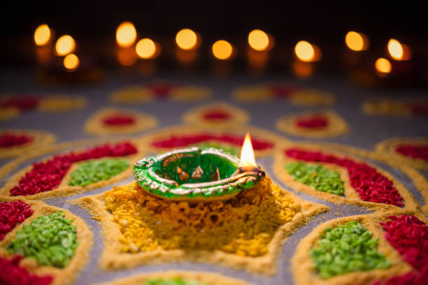 istock Happy Diwali - Diya lamps lit during diwali celebration 1434883580