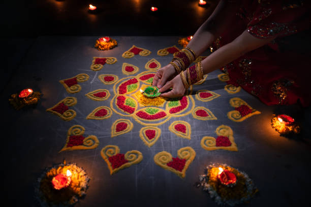istock Happy Diwali - Diya lamps lit during diwali celebration 1434884104