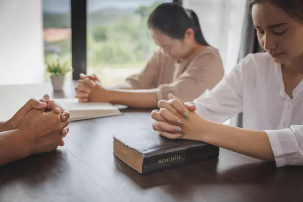 Photo of Woman Pray for god blessing to wishing have a better life. begging for forgiveness and believe in goodness. Christian life crisis prayer to god. Religious concepts.