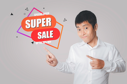 Young man choosing screen SUPER SALE discount banner promotion.