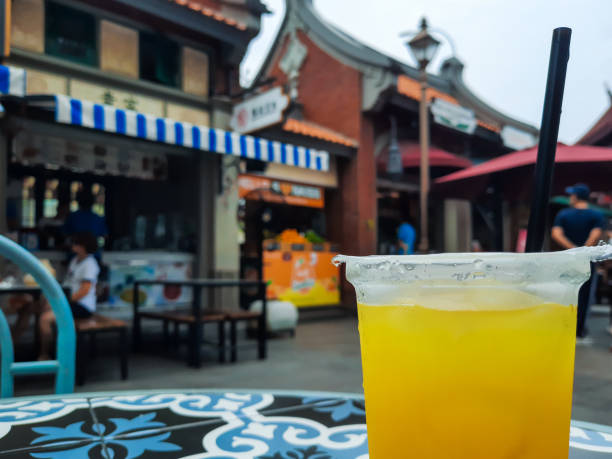 Orange juice in a plastic glass on the table